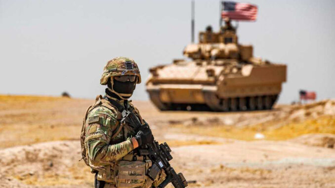 A US soldier stands near a Bradley Fighting Vehicle (BFV) during