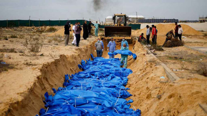 Palestinians killed in Israeli strikes are buried in a mass grave in Khan Younis