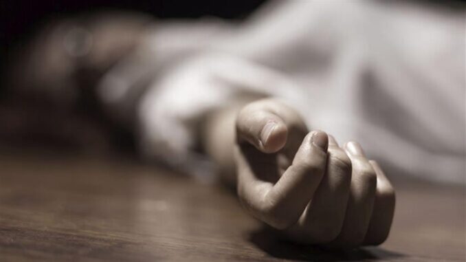 The dead woman's body. Focus on hand