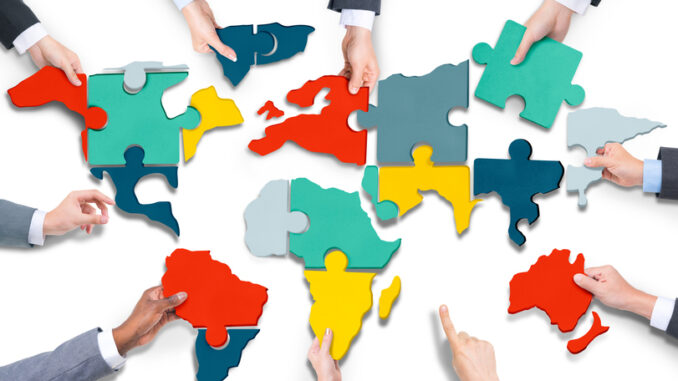 Diverse Business People's Hands with Cartography Puzzle